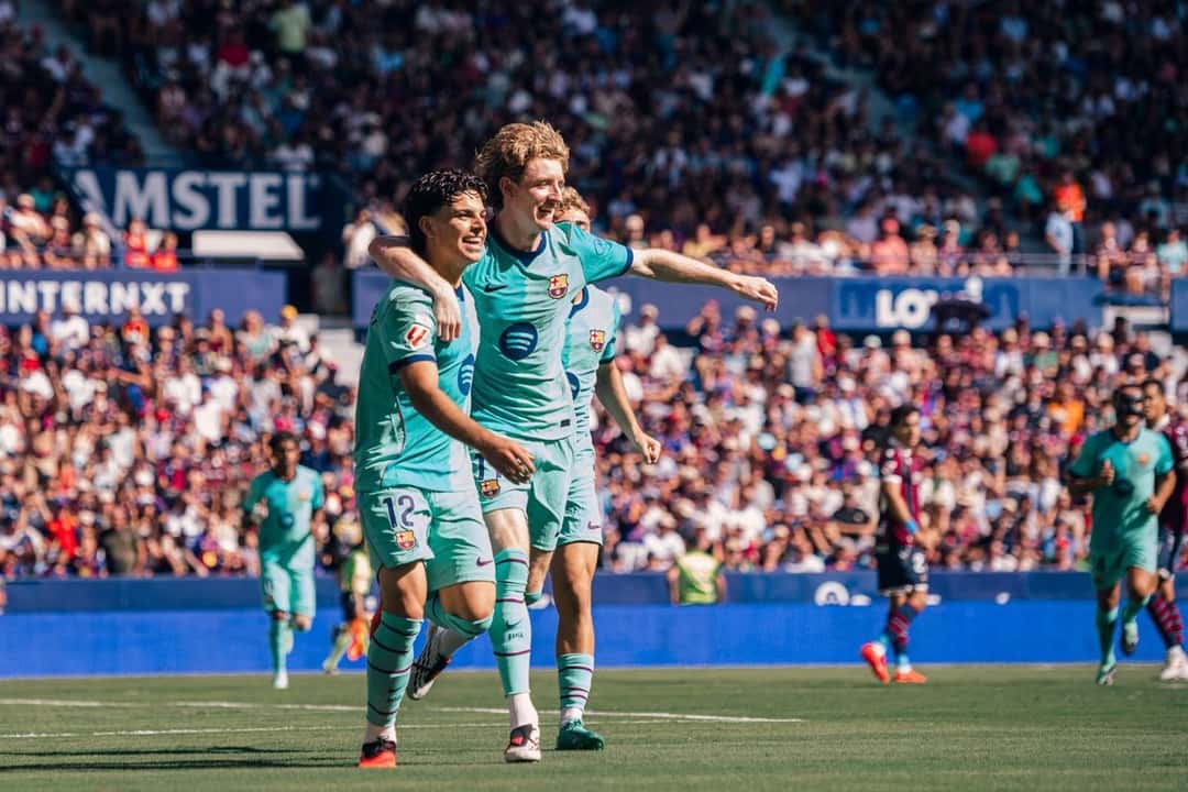 Xavi Espart, con el número 12 y la camiseta celeste del Barcelona, festeja con un compañero en un partido de LaLiga; foto de archivo de septiembre de 2026 (foto: FC Barcelona)