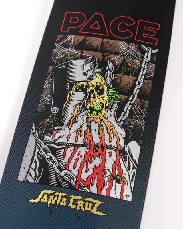Detalle de la tabla «Dungeon» de Rob Pace: una calavera verde con casco de hierro, cadenas y arañas, con el nombre PACE arriba y el logo amarillo de Santa Cruz abajo