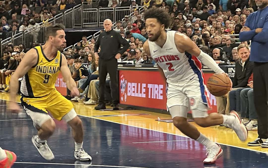 Foto de archivo: Cade Cunningham, con la camiseta blanca número 2 de los Pistons, avanza con la pelota ante un defensor de Indiana