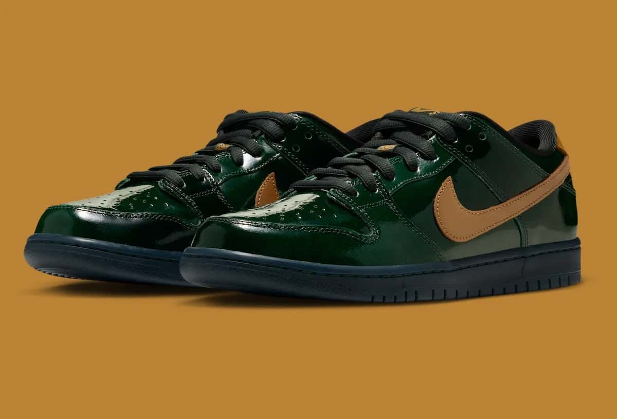 Par de Nike SB Dunk Low Champagne en charol verde oscuro con Swoosh dorado y suela negra, sobre fondo color mostaza